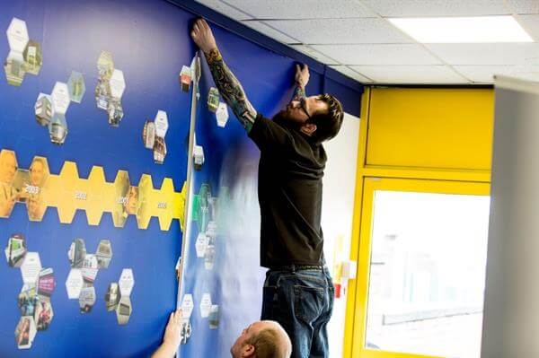 man hanging clear cover on the wall