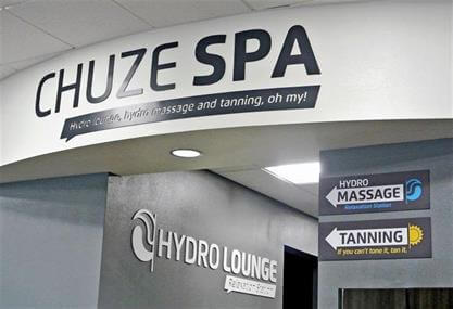 Wayfinding signs used by Chuze Fitness that reflect brand styles