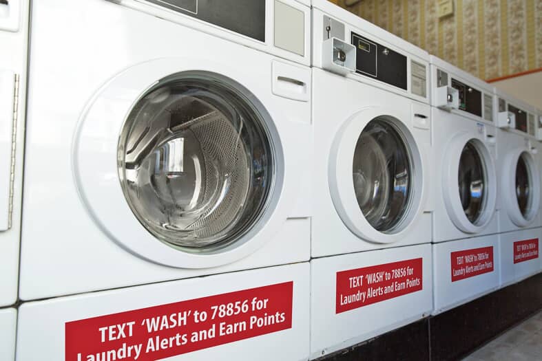 red decal sign with white text on washing machine