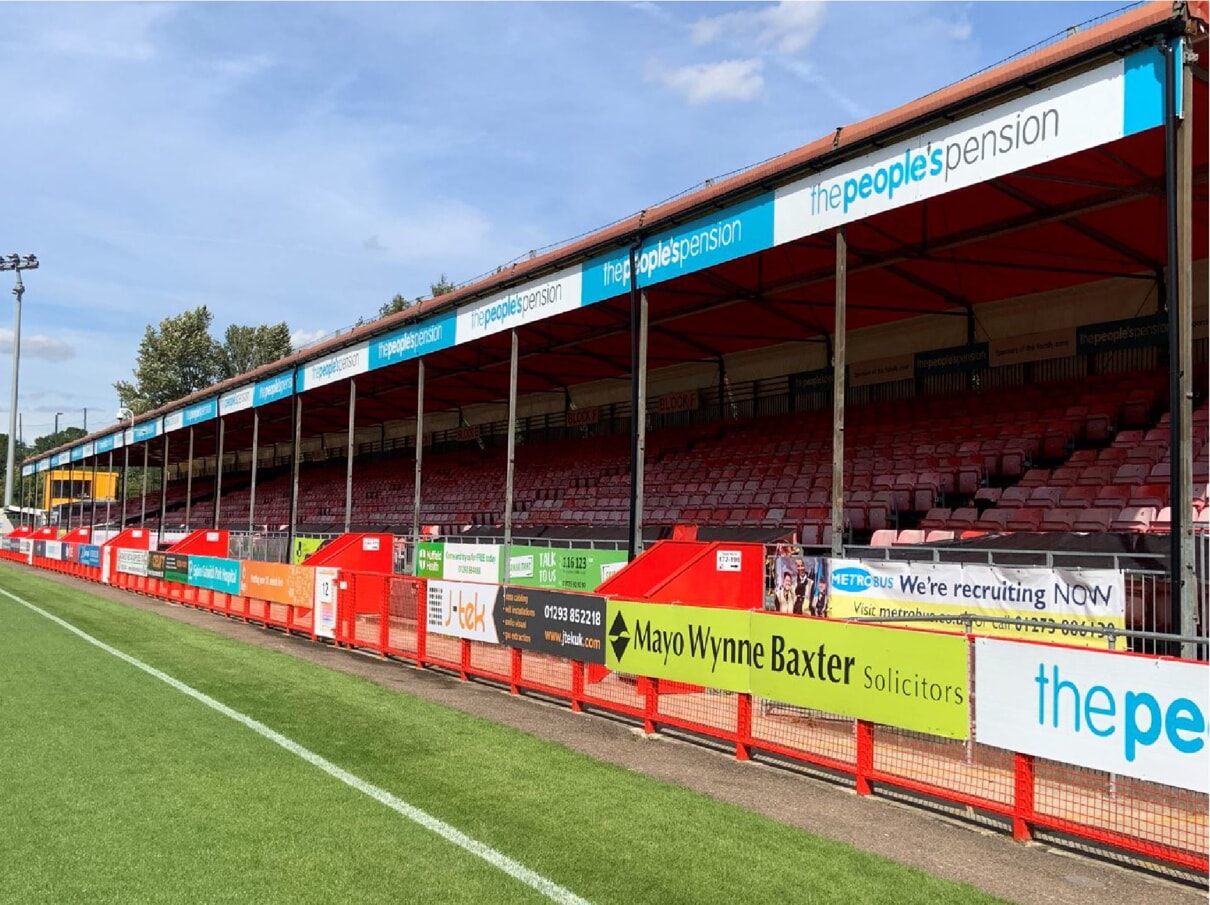 fence sign holder along stadium fence