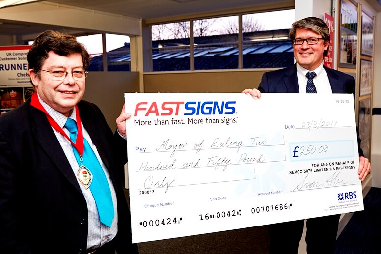 Two Men holding a big cheque
