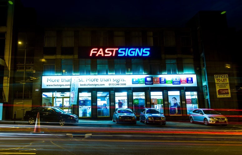 Front sode of a Building with Lighted Signage