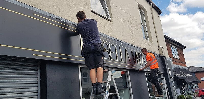 Men working on an outdoor signage