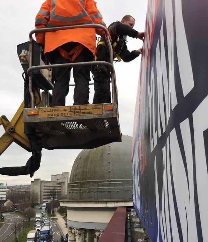 People attaching Printed Banners