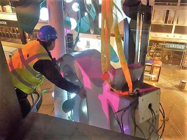 Man working on putting up an outdoor signage