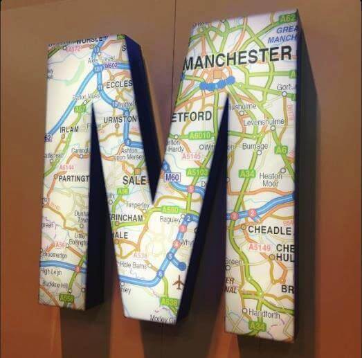 Letter M with map on the wall