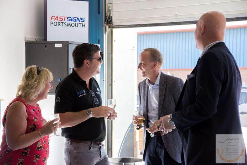 Local business owners enjoying the FASTSIGNS® Portsmouth opening