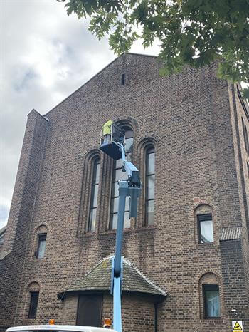 Man working on church window