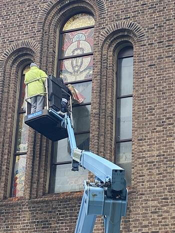 Man working on church window